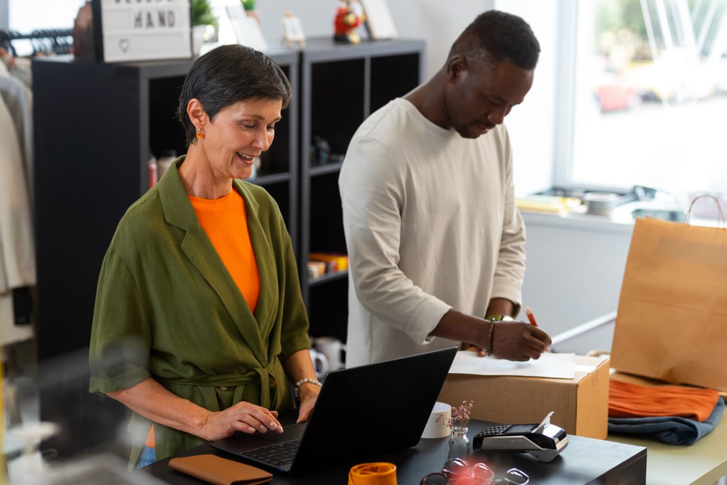 A lady at the counter working on a laptop.